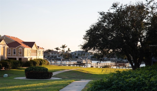 view of community with a water view and a lawn