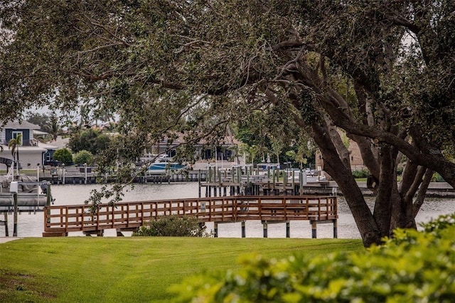 view of home's community with a yard and a boat dock