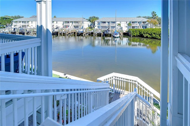 dock area with a residential view and a water view