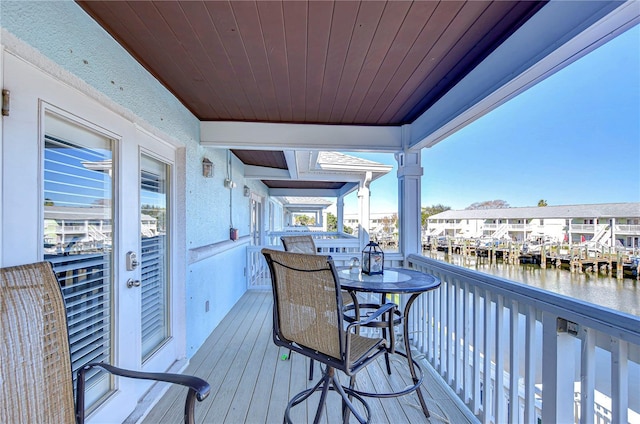 wooden deck featuring a water view