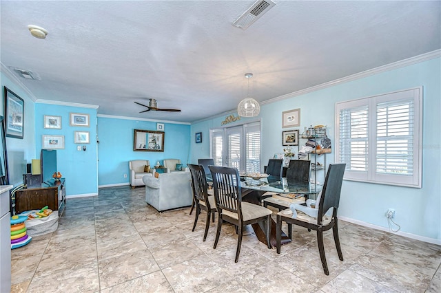 dining space with ceiling fan, crown molding, and a healthy amount of sunlight