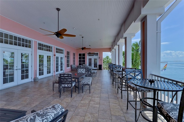 view of patio featuring a water view and french doors