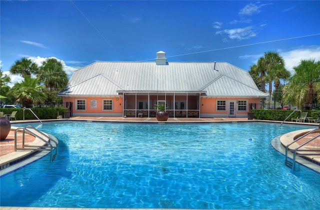 view of swimming pool featuring a patio and french doors