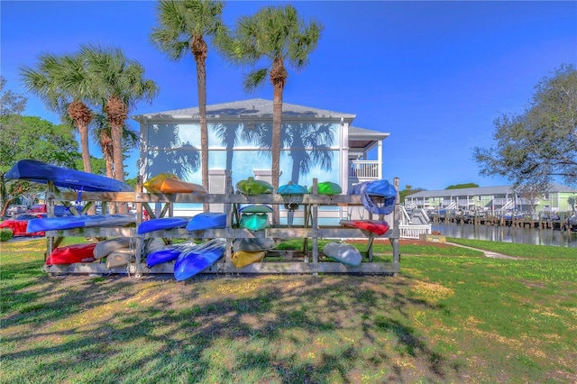 exterior space featuring a water view and a yard