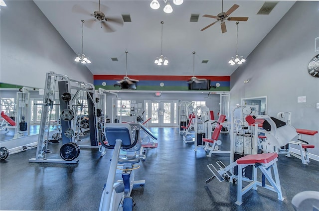 workout area with ceiling fan with notable chandelier, high vaulted ceiling, and french doors