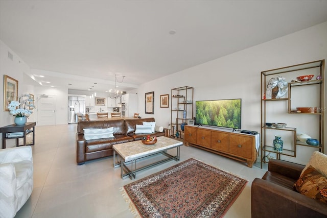 living room featuring light tile patterned floors and an inviting chandelier