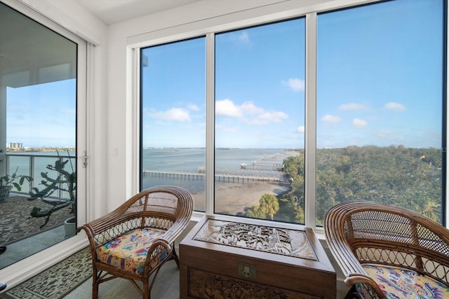 sunroom / solarium featuring a water view