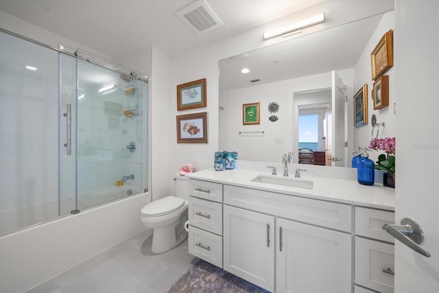 full bathroom with shower / bath combination with glass door, vanity, and toilet