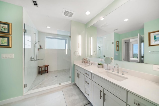 bathroom featuring a wealth of natural light, tile patterned flooring, vanity, and walk in shower