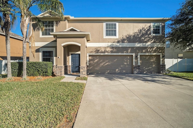 view of front of house with a garage and a front yard