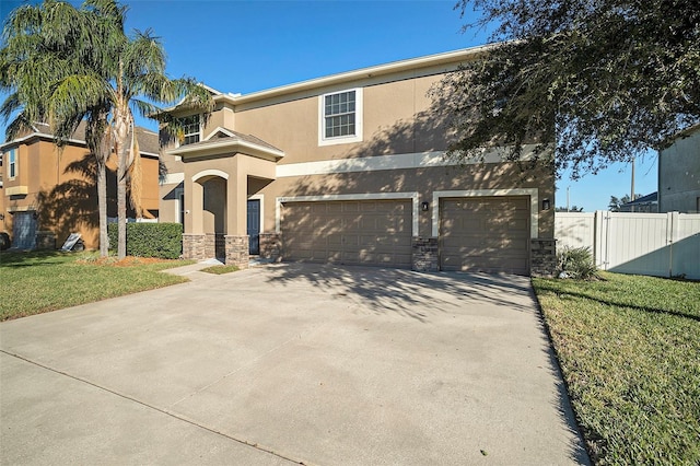 view of front of property with a front yard and a garage