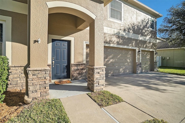 view of exterior entry with a garage