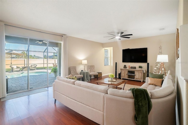 living room featuring wood-type flooring and ceiling fan