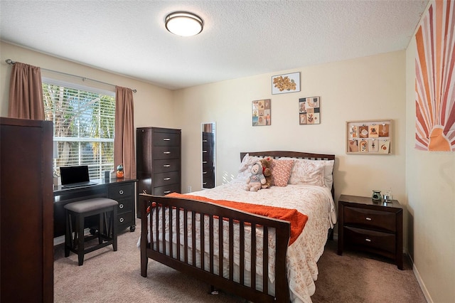 carpeted bedroom featuring a textured ceiling