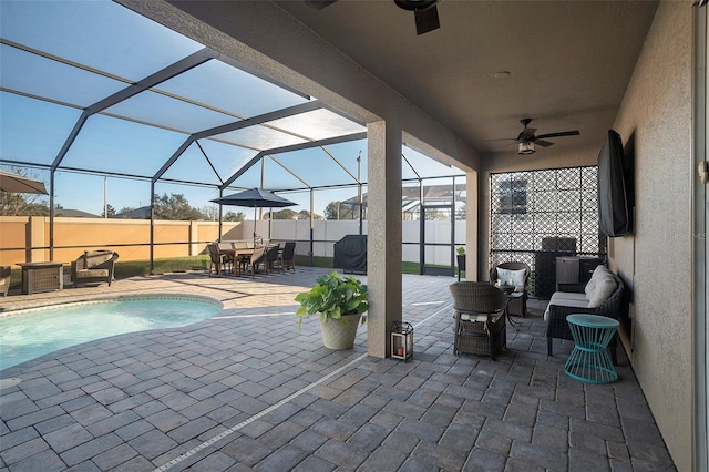 view of patio / terrace featuring an outdoor living space, a fenced in pool, glass enclosure, and ceiling fan