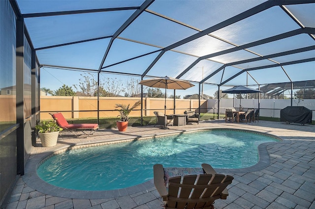 view of pool featuring a lanai, area for grilling, and a patio