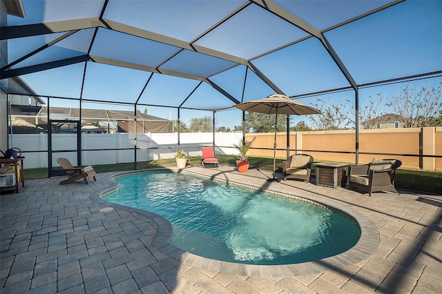 view of swimming pool with glass enclosure and a patio area