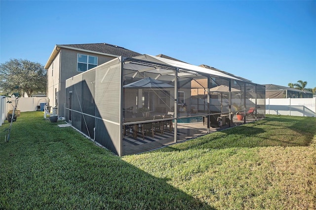 view of yard with glass enclosure, a fenced in pool, and a patio