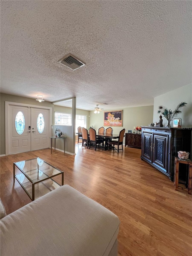 living room featuring hardwood / wood-style flooring and a textured ceiling