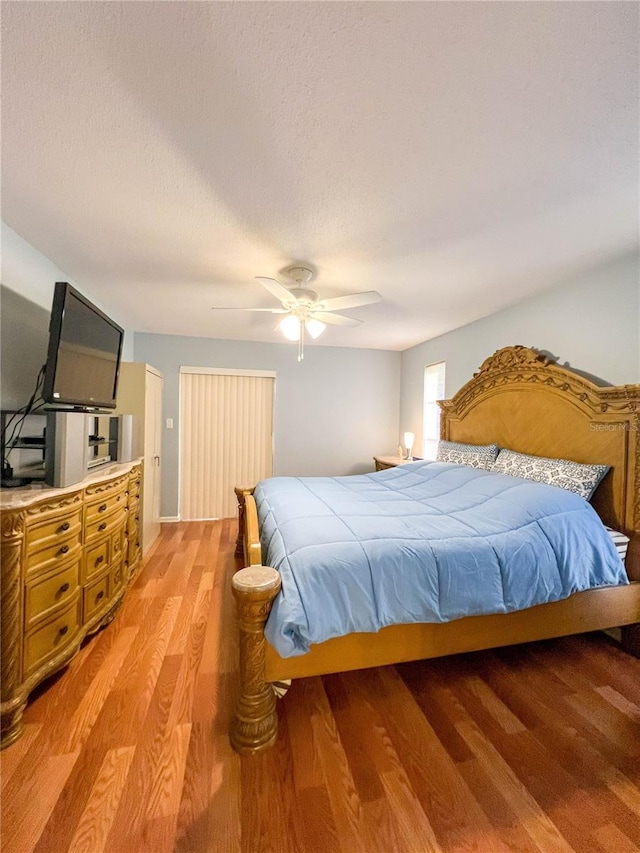 bedroom with ceiling fan and hardwood / wood-style flooring