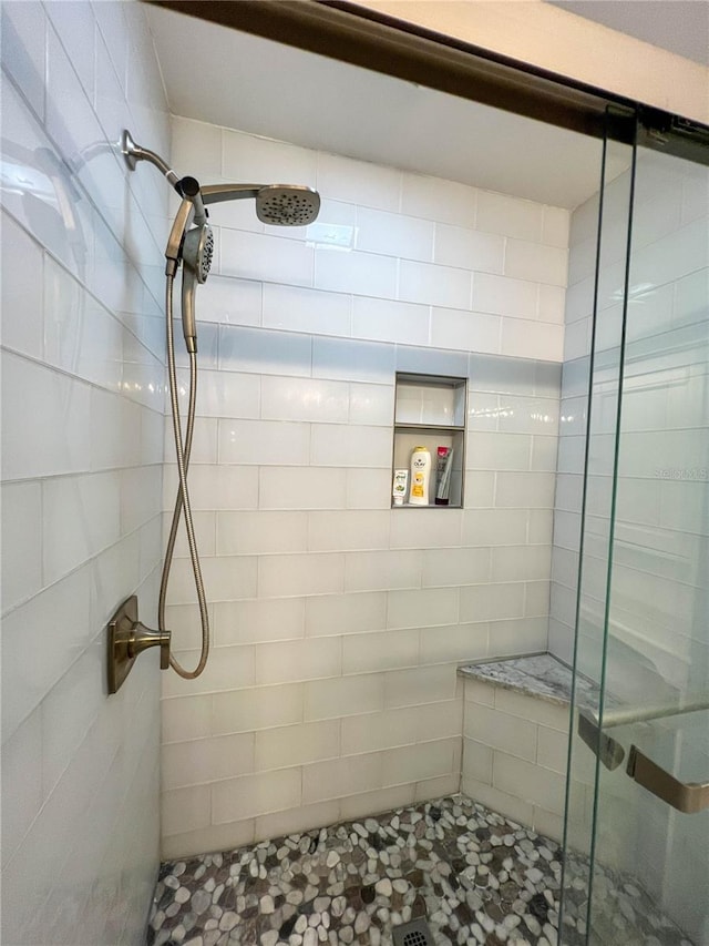 bathroom with a shower with shower door