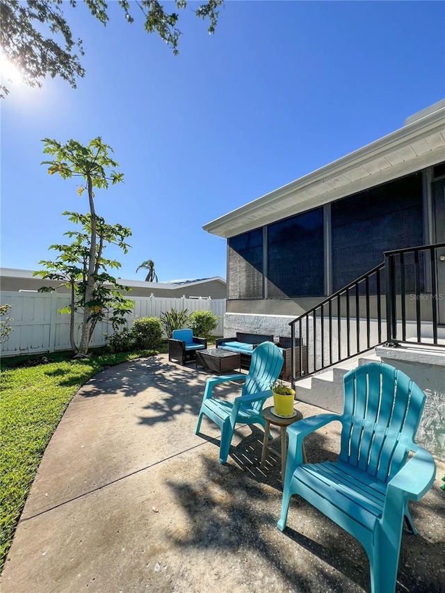 view of patio / terrace featuring a sunroom