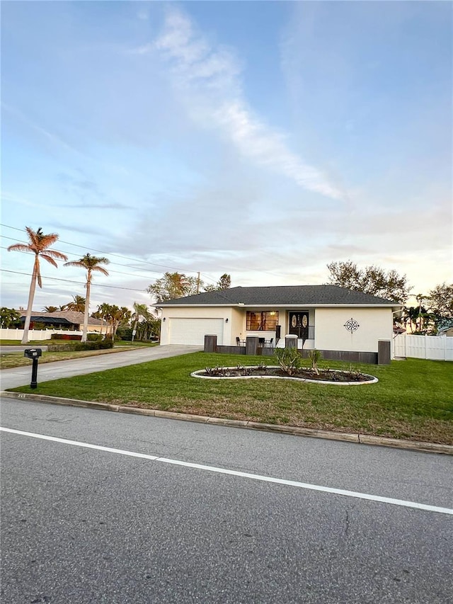 ranch-style house with a front lawn and a garage