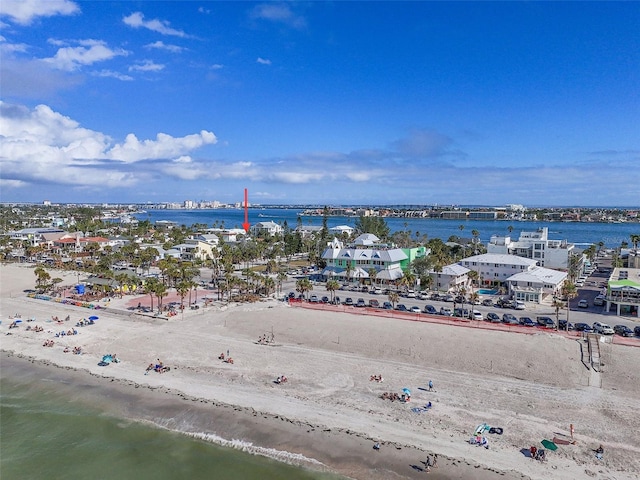 birds eye view of property with a water view and a view of the beach