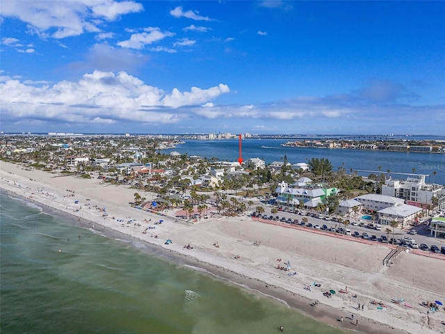 birds eye view of property with a water view and a beach view