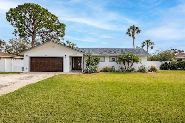 ranch-style house featuring a garage and a front lawn