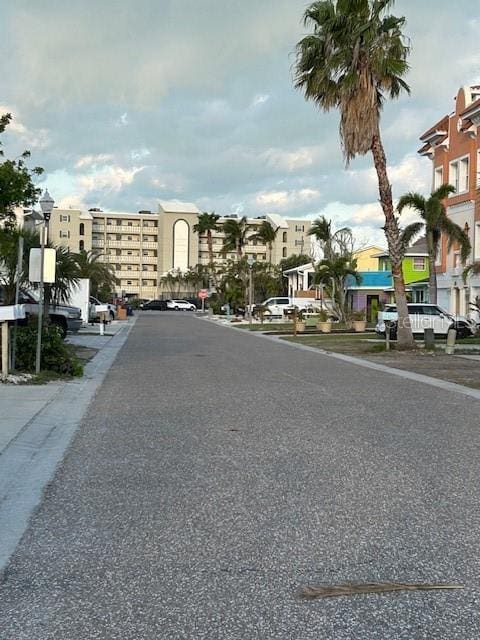 view of road with a residential view and street lights
