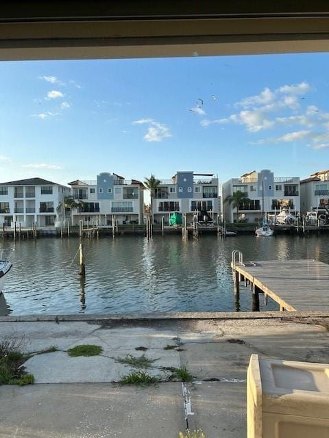 view of dock featuring a water view and a residential view