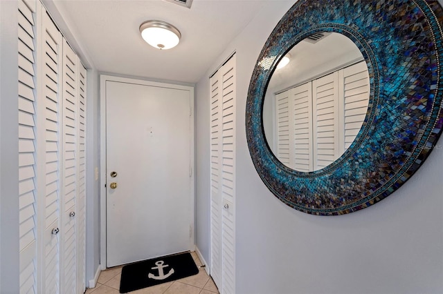 doorway to outside featuring light tile patterned floors