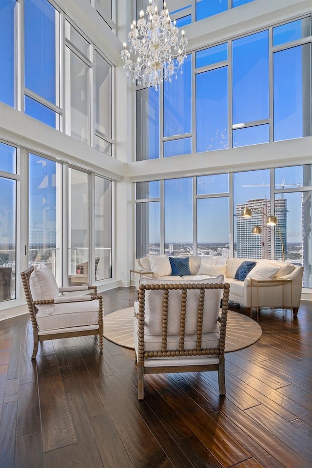 sunroom / solarium with a chandelier