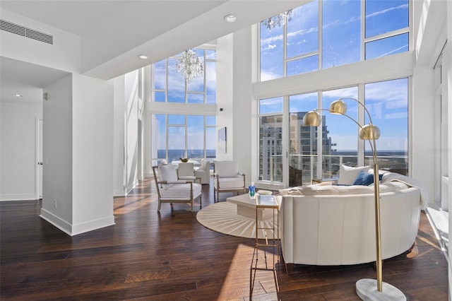 living room featuring dark hardwood / wood-style flooring and a towering ceiling