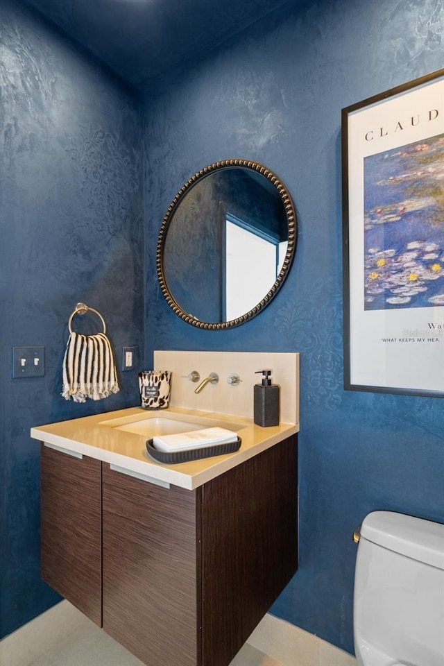 bathroom featuring vanity and toilet