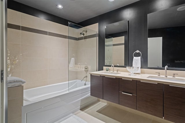 bathroom with tile patterned flooring, vanity, and tiled shower / bath combo