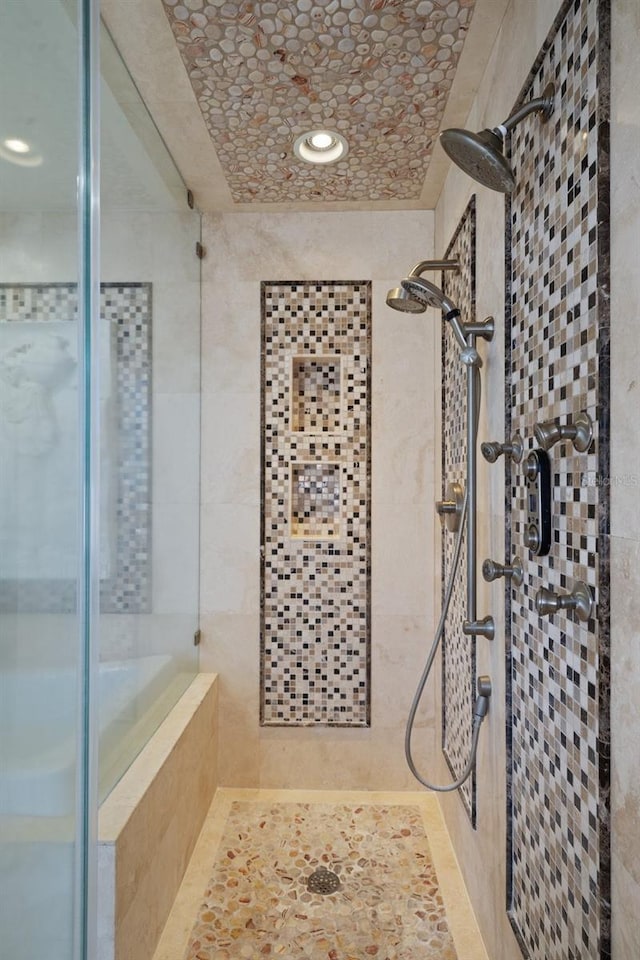 bathroom with a tile shower