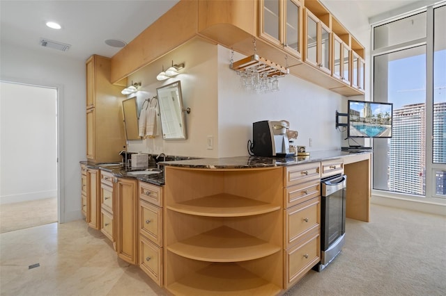 kitchen with light carpet, light brown cabinetry, kitchen peninsula, sink, and dark stone countertops