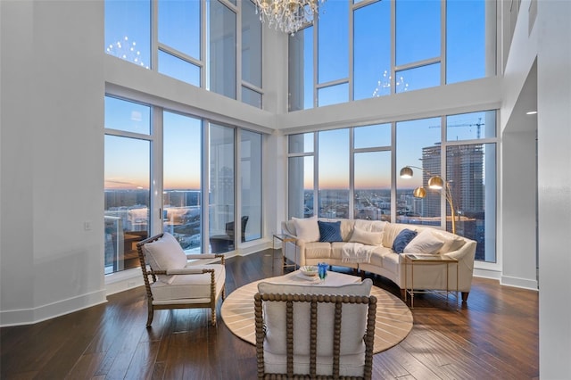 living room featuring hardwood / wood-style floors, a healthy amount of sunlight, and a high ceiling