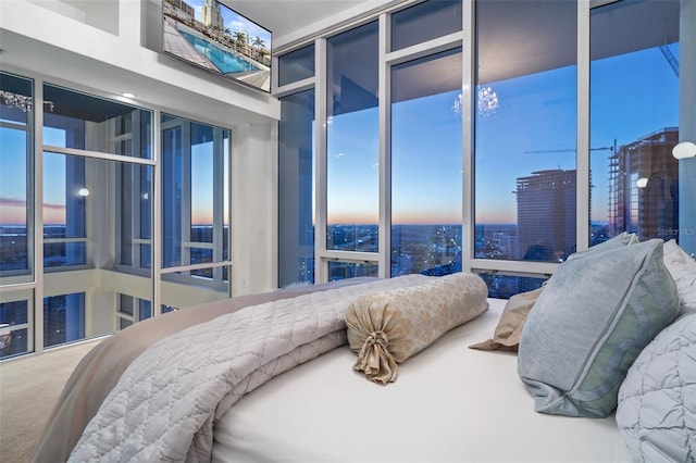 bedroom featuring floor to ceiling windows and carpet