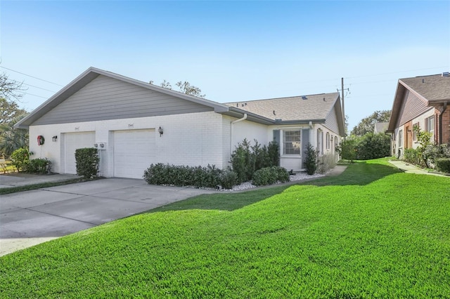 view of side of property with a lawn and a garage