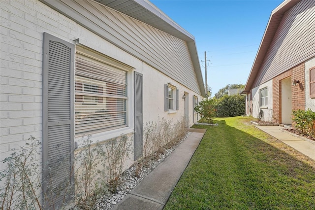 view of home's exterior with a lawn