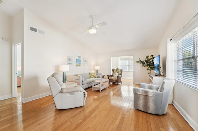 living room featuring ceiling fan, light hardwood / wood-style floors, lofted ceiling, and a wealth of natural light