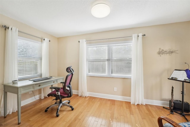 office space with light hardwood / wood-style flooring and a wealth of natural light