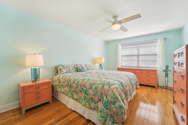 bedroom with ceiling fan and light hardwood / wood-style flooring