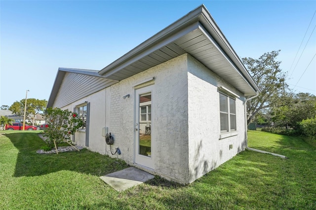 view of side of property with a lawn