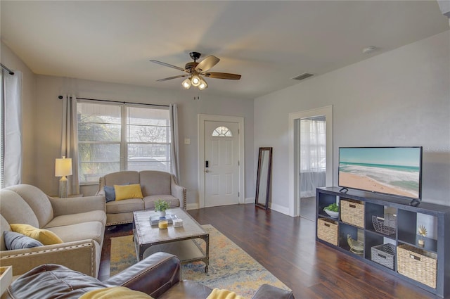 living room featuring dark hardwood / wood-style flooring and ceiling fan