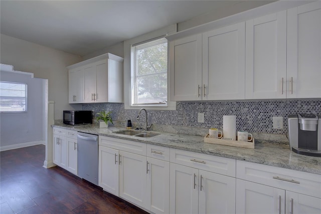 kitchen featuring sink, tasteful backsplash, light stone counters, dishwasher, and white cabinets