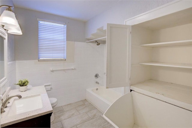 full bathroom featuring tile patterned flooring, tile walls, vanity, shower / bathing tub combination, and toilet